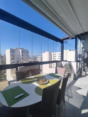 a dining room with a table and chairs on a balcony at Wafa in Casablanca