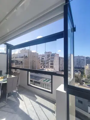 a room with a large window with a table and chairs at Wafa in Casablanca
