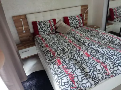 a bedroom with a bed with a black and white comforter at Wafa in Casablanca