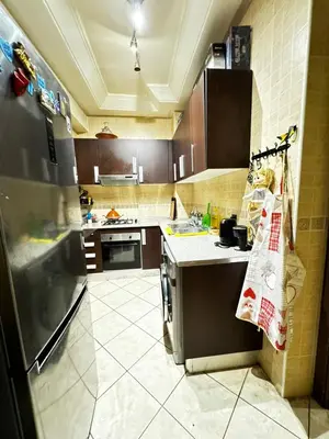 a kitchen with a refrigerator and a counter top at Jardin mohammedia in Mohammedia
