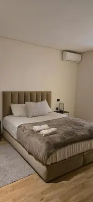 a bedroom with a large bed with two towels on it at Appartement Oasis in Casablanca