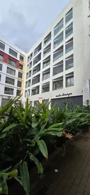 a building with a bunch of plants in front of it at Appartement Oasis in Casablanca