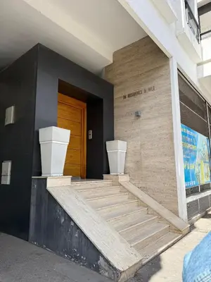 a building with stairs and a wooden door at Appartement Sacré-Cœur in Casablanca