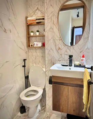 a bathroom with a toilet and a sink at Kawtar in Mansouria