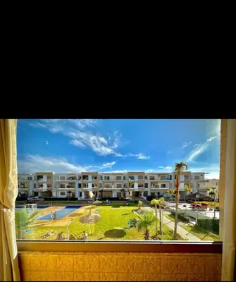 a window with a view of a large apartment complex at Kawtar in Mansouria