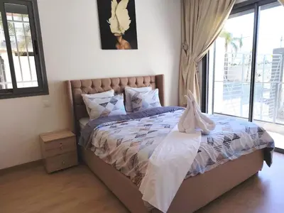 a bedroom with a bed with a large window at Your comfortable stopover in Nouaseur