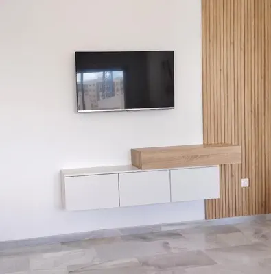 a tv on a white wall with a television on it at Your comfortable stopover in Nouaseur