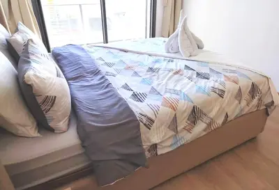 a bed with a quilt and pillows on it at Your comfortable stopover in Nouaseur