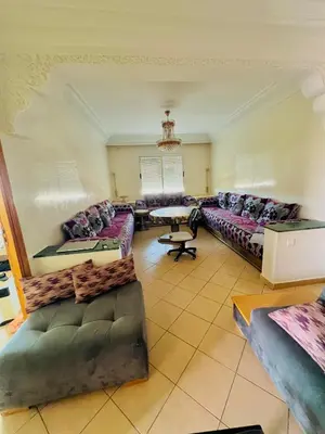 a large living room with couches and a table at Apparemment à louer au centre ville Bouznika in Bouznika