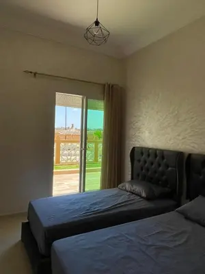 a bedroom with two beds and a window at Kawtar in Pont Blondin