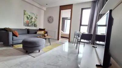 a living room with a couch and a table at Modern apartment in Casablanca in Casablanca