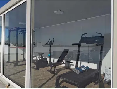 a gym with several exercise bikes and a window at Modern apartment in Casablanca in Casablanca