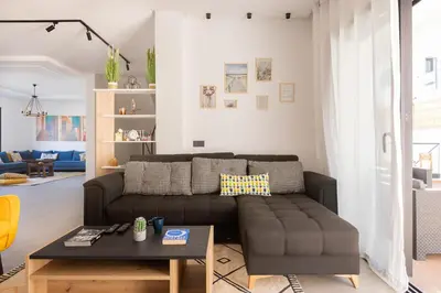 a living room with a couch and a table at Beach Vibe Villa - Sunny Stay in O Ben Slimane