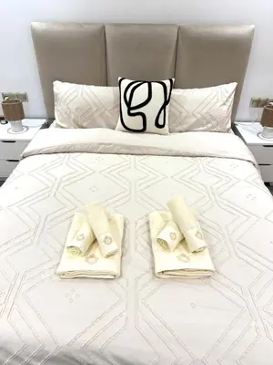 a bedroom with a bed with two towels on it at Beautiful spacious apartment in Casablanca in Casablanca