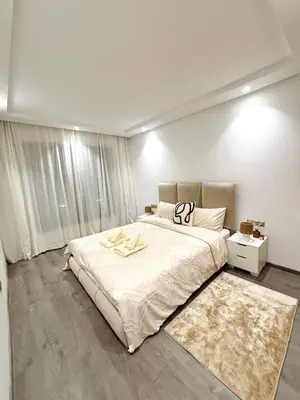 a bedroom with a large bed and a rug at Beautiful spacious apartment in Casablanca in Casablanca