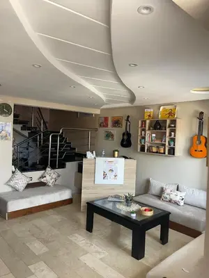a living room with a couch and a table at Chambres Surf,Piano et Arts in Tamaris