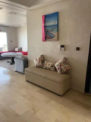 a living room with a couch and a painting on the wall at Chambres Surf,Piano et Arts in Tamaris