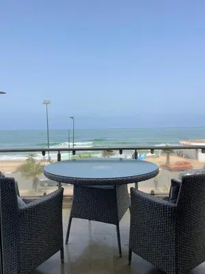a table and chairs with a view of the beach at Chambres Surf,Piano et Arts in Tamaris