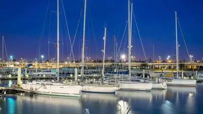 a group of boats docked in a marina at night at La passage inoubliable F in Bouznika