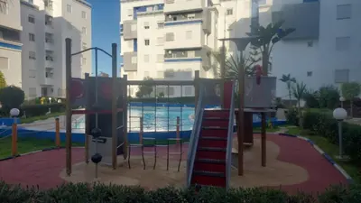 a playground with a slide next to a pool at La passage inoubliable F in Bouznika