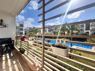 a balcony with a view of a swimming pool at Résidence fal green bouskoura in Bouskoura