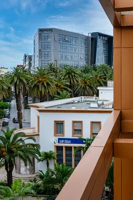 a view from the balcony of a building with palm trees at Appartement au parc à 3 minutes de la plage in Mohammedia