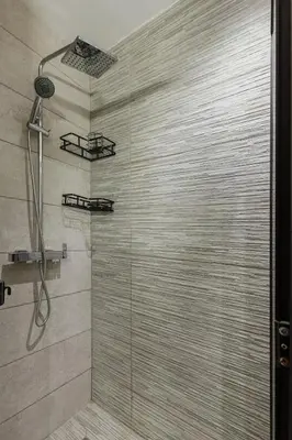 a bathroom with a shower with a glass door at Appartement au parc à 3 minutes de la plage in Mohammedia