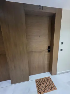 a wooden door in a room with a rug at Résidence EDEN 4 - Casablanca Center in Casablanca