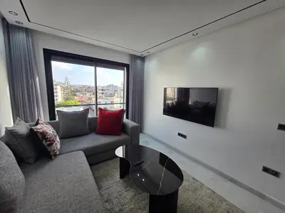 a living room with a couch and a table at Résidence EDEN 4 - Casablanca Center in Casablanca