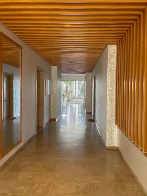 a hallway of a building with a wooden ceiling at Cozy Boho 2BR Prestigia Stadium View in Rabat