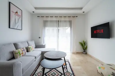 a living room with a couch and a table at Studio Raffiné et Lumineux in Casablanca