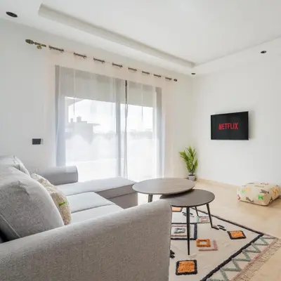 a living room with a couch and a table at Studio Raffiné et Lumineux in Casablanca