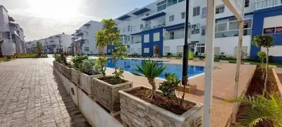 a row of potted plants in front of a building at Appartement avec piscine in Mohammedia