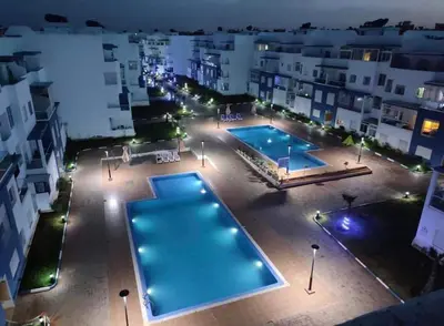 an overhead view of a swimming pool at night at Appartement avec piscine in Mohammedia