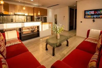 a living room with two red couches and a table at 1BR - Casa Voyageurs - Belvedere in Maarif