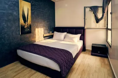 a bedroom with a large bed in a room at 1BR - Casa Voyageurs - Belvedere in Maarif