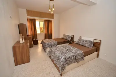 a small bedroom with a bed and a couch at Abdelmoumen Central Spacious Haven in Maarif