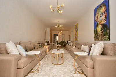 a large living room with couches and a table at Abdelmoumen Central Spacious Haven in Maarif