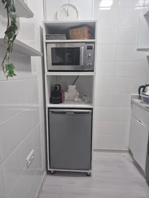 a small kitchen with a microwave and a dishwasher at Studio close to Descartes high school in Rabat