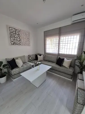 a living room with a couch and a coffee table at Studio close to Descartes high school in Rabat