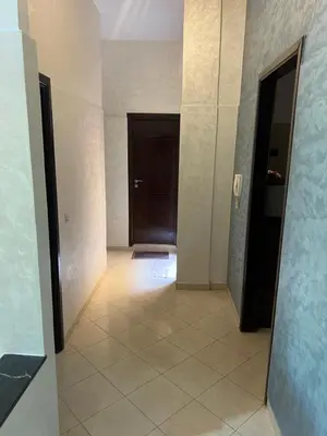 a hallway with a door and a tile floor at Steps to the beach in Sidi Rahal