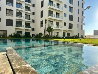 a swimming pool in front of a building at CosmoStay Airport Casablanca Appart in Nouaseur