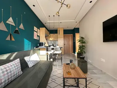 a living room with a couch and a table at CosmoStay Airport Casablanca Appart in Nouaseur