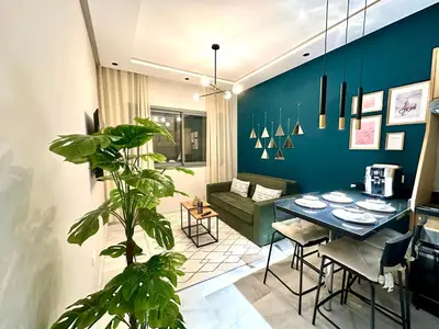 a living room with a table and a couch at CosmoStay Airport Casablanca Appart in Nouaseur