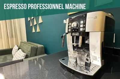 a espressoprocessorprocessor machine sitting on a counter with glasses at CosmoStay Airport Casablanca Appart in Nouaseur