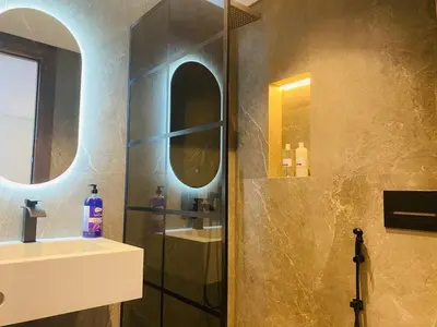 a bathroom with a shower and a sink and a mirror at spectrum studio in Casablanca