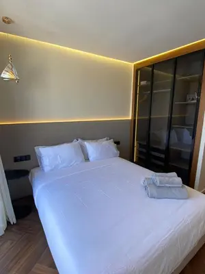 a large white bed with two towels on it at spectrum studio in Casablanca