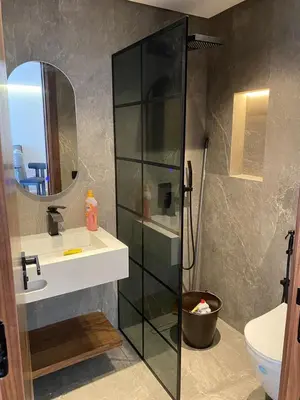 a bathroom with a shower and a sink and a mirror at spectrum studio in Casablanca