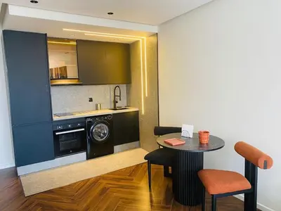 a kitchen with a washing machine and a table with chairs at spectrum studio in Casablanca