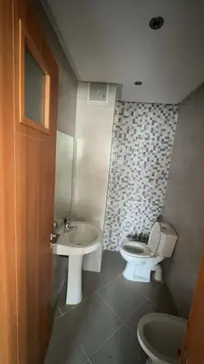 a bathroom with a toilet and a sink at dekra bouznika in Bouznika